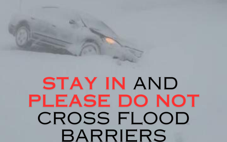 STAY IN and PLEASE DO NOT cross flood barriers